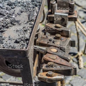 Historical tools of a blacksmith at a medieval market such as hammer, chisel, broach, chisel, beating plate, pestle, axe, pliers, axe, iron, in Germany